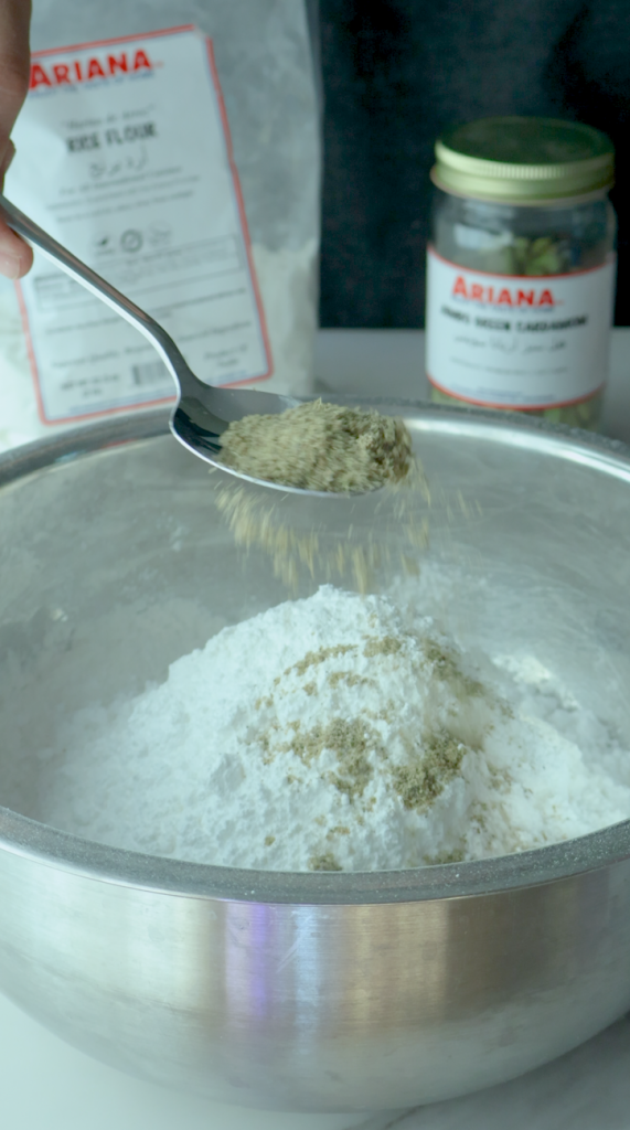 Add rice flour, powdered sugar, baking powder, baking soda and ground cardamom and mix together. 